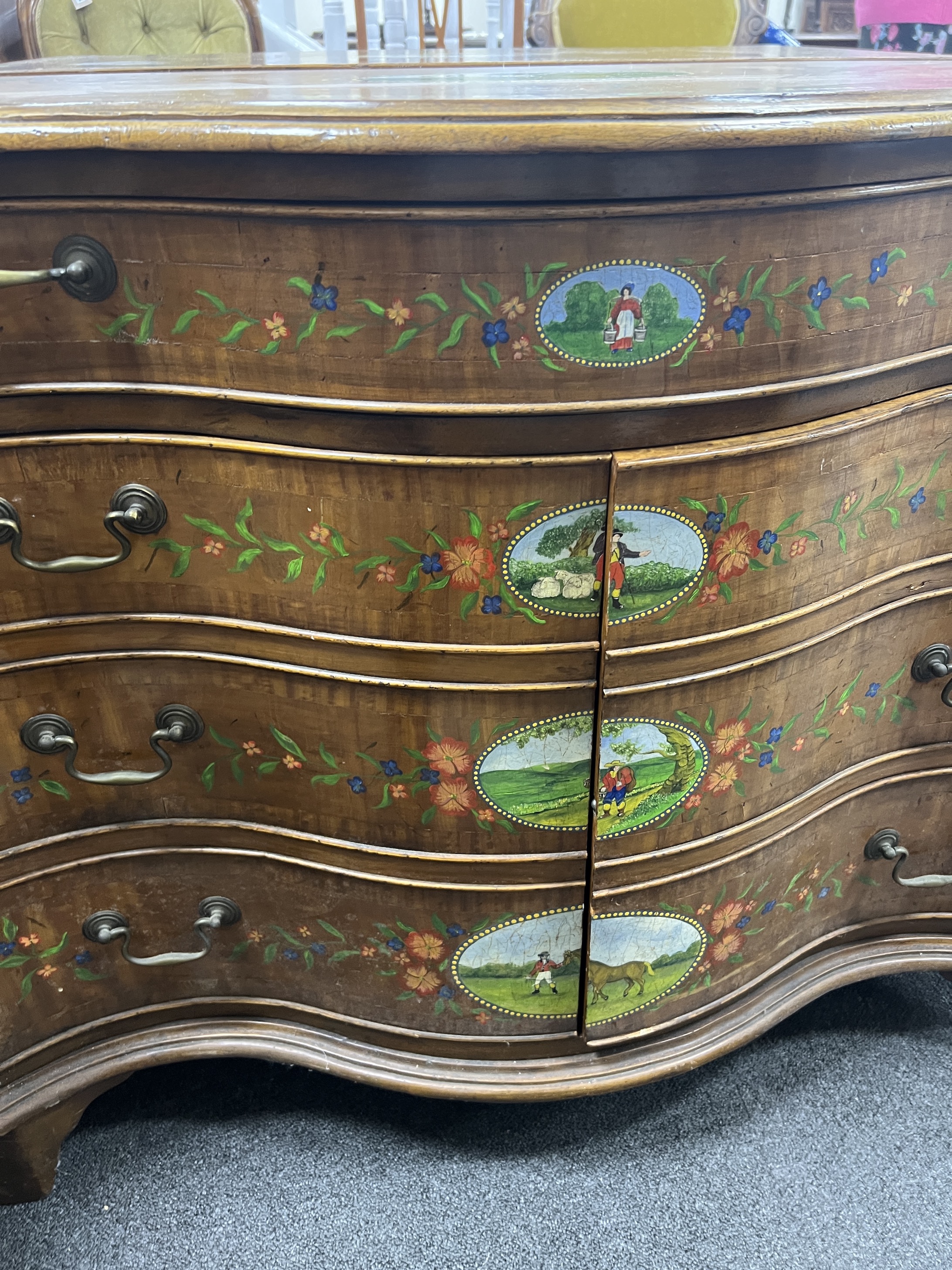 A George III style painted satinwood serpentine chest with part dummy drawer front, width 91cm, depth 48cm, height 75cm